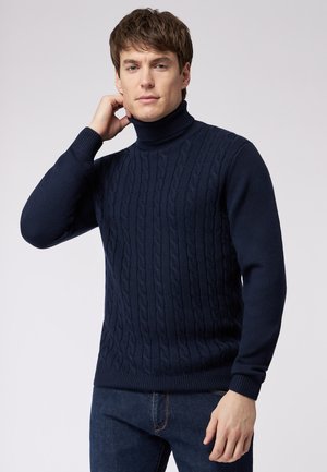 Marineblauer Rollkragenpullover mit einem strukturierten Zopfmuster. Mit gerippten Bündchen und Saum, aus einem weichen, mittelschweren Material gefertigt.