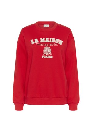 Sweatshirt rouge en tissu doux, avec du texte blanc : "LA MAISON VOTRE LIEU PRÉFÉRÉ FRANCE," et des poignets et un ourlet côtelés.