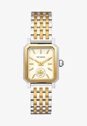 Suunnikkaan muotoinen Tory Burch -kello, jossa on kultainen ja hopeanvärinen metalliranneke, kermaisen värinen kellotaulu, kultaiset tuntimerkit, logo keskellä ja oktaalinen kultasävyinen kehys.
