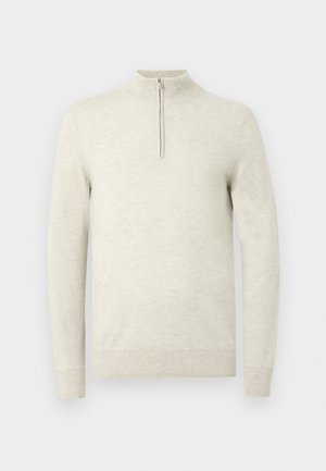 Light beige pullover sweater with a high neck and quarter-zip closure. Features long sleeves and a soft, textured fabric.
