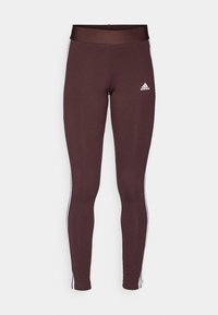 Bruna atletiska leggings med hög midja, med vita sidosträck och en liten vit logotyp på vänster lår. Slät textur.