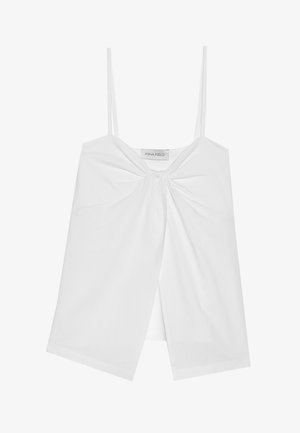 Top alb fără mâneci, cu bretele subțiri, având un detaliu cu fundiță în față și un design despicat în partea de jos. Material neted, ușor.