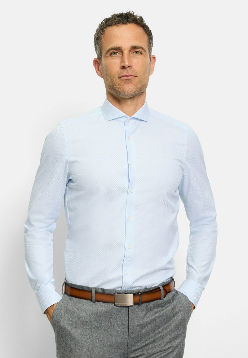 Hellblaues, knöpfbares Hemd mit einem dezent geometrischen Muster, langen Ärmeln und einem Kragen, kombiniert mit grauen Hosen und einem braunen Gürtel.