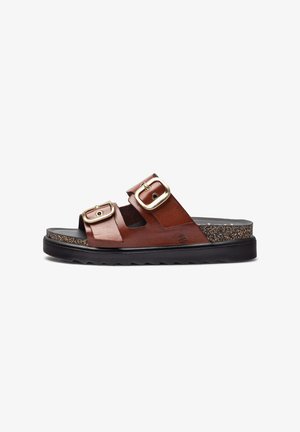 Brown leather sandal with two wide straps, featuring gold-tone buckles. Textured cork footbed and black rubber outsole with a tread design.