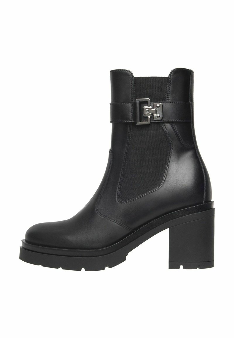 Black leather ankle boot with chunky heel, elastic side panel, and decorative silver buckle strap on white background.
