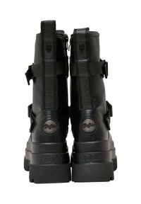 Czarne botki za kostkę z chunky podeszwą, gładkim skórzanym materiałem, dużymi paskami i akcentami logo z tyłu. Zamek błyskawiczny z boku.