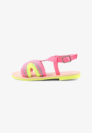 Sandali rosa con un design arcobaleno all'uncinetto caratterizzato da tocchi di giallo, verde e rosa. Cinghietta regolabile alla caviglia e suola piatta in rosa chiaro.
