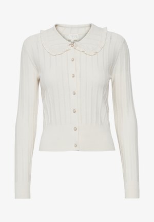 Ivory cardigan with a ruffled collar, long sleeves, textured rib design, and pearl button closures. Fitted at the waist.