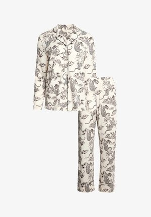 Set di pigiama crema a maniche lunghe con piping nero, caratterizzato da stampa leopardata e di foglie su tutta la superficie della camicia con bottoni e pantaloni con vita elasticizzata.