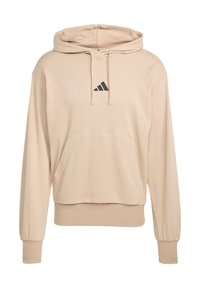 Sudadera beige de tejido suave, con bolsillo tipo canguro, capucha con cordón y logo negro de Adidas en el pecho. Corte holgado con puños de canalé.