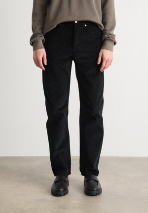 Black corduroy pants with a straight leg cut, featuring a button and zipper closure, frontal pockets, and a soft, textured fabric.
