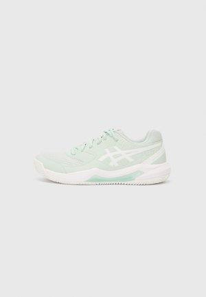 Light green athletic shoe with mesh upper, white accents, and a sturdy white sole. Features laces and a cushioned heel for support.