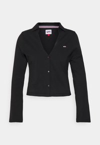 Black long-sleeve shirt with a v-neck, button closure, and small logo on the left chest. Made from soft, stretchy fabric with a tailored fit.