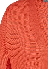 Offene Strickjacke in leuchtendem Orange. Mit V-Ausschnitt und geripptem Saum an den Kanten. Leichte, atmungsaktive Textur mit lockerer Passform.