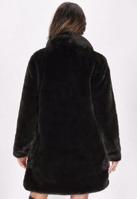 Black faux fur coat with a high collar, long sleeves, and a loose fit. The texture is soft, creating a plush appearance.