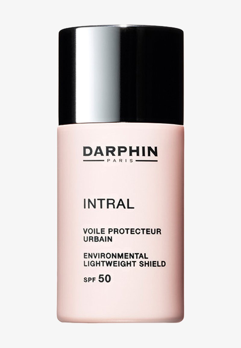 Darphin Intral sunscreen with SPF 50 in a pale pink cylindrical bottle, topped with a shiny black cap. Features clear label text.