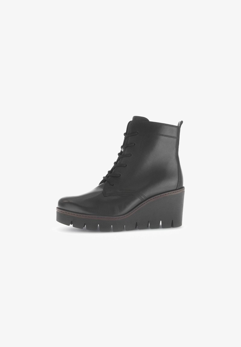 Black leather ankle boot with a rounded toe, wedge sole, lace-up front, and detailed stitching along the edges. Textured finish.