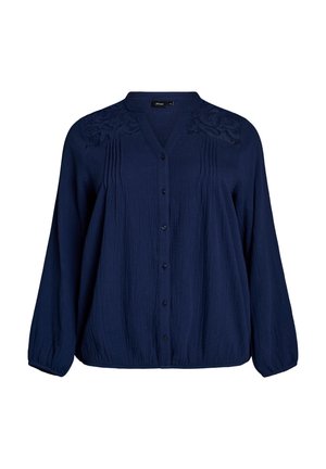 Tmavě modrá halenka s dlouhým rukávem, zapínáním na knoflíky, zdobením sklady, vyšívanou vsadkou a elastickými manžetami a lemem.
