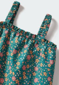 Blommig topp i teal tyg, med samlade elastiska band, smockad halsringning och ett mönster av rosa och gula blommor med gröna blad.