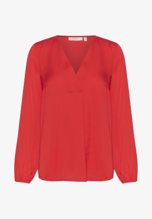 Kerge kangast punane pluus, millel on V-kaelus, pikad varrukad elastsete mansettidega ning tagasihoidlik eesmine voldi detail.