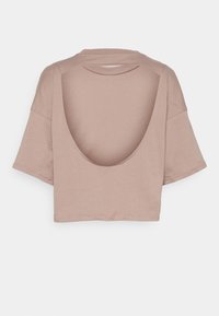 Kortärmad, kort topp i ljus beige. Har en vid, djup öppen rygg och mjukt, lätt bomullstyg.