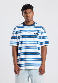 Striped t-shirt featuring blue and white horizontal stripes, ribbed navy collar, and "NYC" text in black on the left chest area.