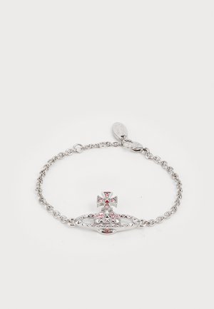 Silver chain bracelet featuring a textured, crown-shaped charm with pink gemstones and a cross accent, displaying intricate detailing.