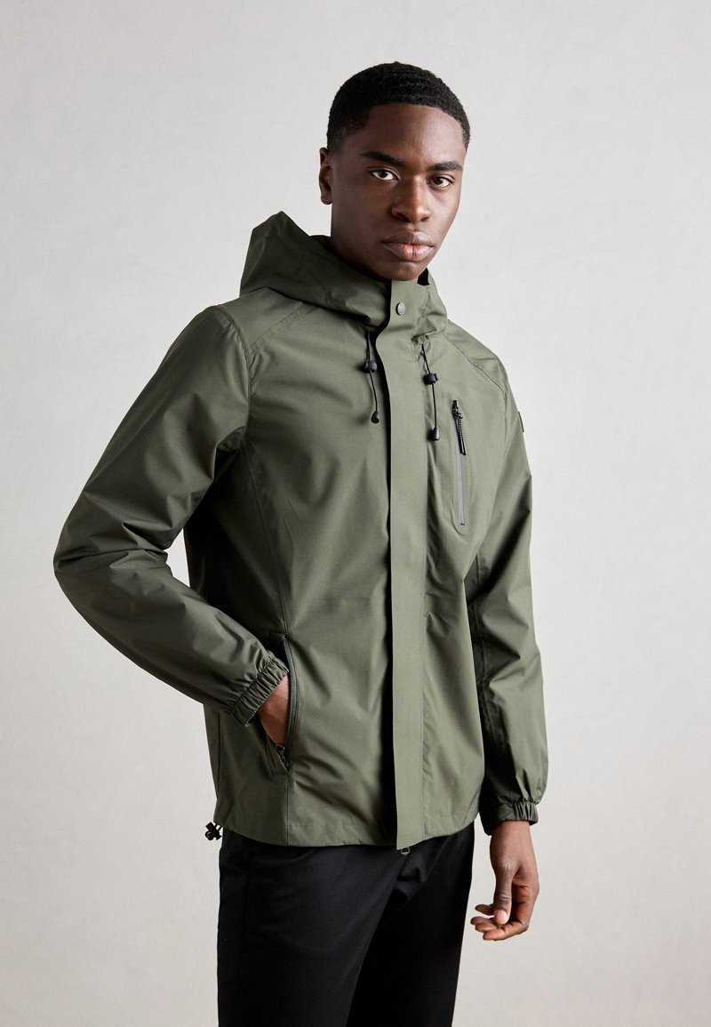 Olive green waterproof jacket featuring a hood, elastic cuffs, and zippered chest pocket. Smooth texture with minimalistic design.