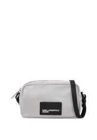 Malá obdélníková světle šedá crossbody taška s černým nastavitelným popruhem a logem "Karl Lagerfeld Jeans" na přední straně.