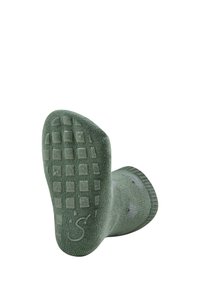 Grüne strukturierte Socken mit einer gepolsterten Sohle, die gummierte Griffmuster und einen engen, gerippten Bund für zusätzlichen Komfort bieten.