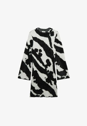 Pitkähihainen, pörröinen mekko valkoisena mustilla abstrakteilla kuvioilla, pyöreällä kaula-aukkolla ja suoralinjaisella siluetilla. Pehmeä pinta, puolipitkä.