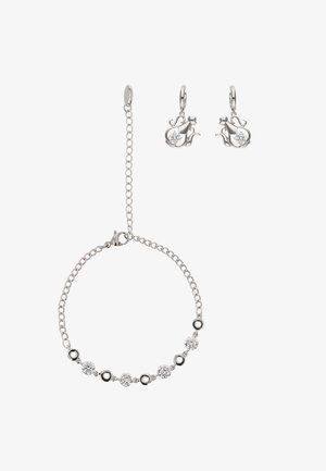 Zilveren sieradenset met een armband met ronde zwarte en transparante stenen, en oorbellen met een vergelijkbaar ontwerp en transparante edelsteendetails.