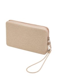 Beige zippered wallet with a textured surface, featuring a subtle sparkle, and a wrist strap. Logo embossed on the front.