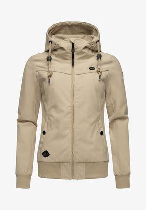 Beige színű, könnyű dzseki kapucnival, cipzárral és oldalsó zsebekkel. Fekete kiegészítők és elasztikus mandzsetta jellemzi. Simább, tartós anyag.