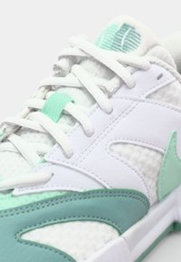 Hvid sneaker med mintgrønne accenter. Har en tekstureret mesh-overdel og syntetiske overlejringer. Snørebåndslukning og polstret tunge for komfort.