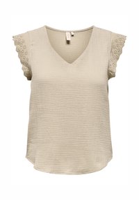 Haut beige à manches courtes avec un col en V, présentant un tissu texturé et des accents en dentelle festonnée sur les manches. Ourlet arrondi.