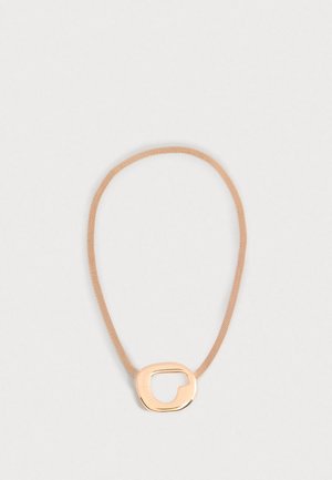 Rose gold mesh necklace featuring an abstract oval pendant with a cut-out design, presenting a smooth metallic finish and a soft texture.