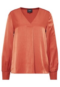 Blouse couleur rouille avec un col en V, des manches longues bouffantes et une texture lisse. Comprend un pli sur le devant et des poignets ajustés.