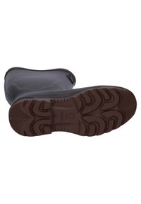 Black rubber boot underside with a brown textured outsole featuring a wavy pattern and defined tread for grip. Leaf logo on heel area.