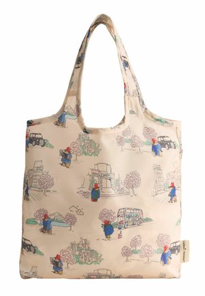 Sac fourre-tout beige réutilisable présentant des illustrations de Paddington Bear dans diverses scènes urbaines avec des voitures, des bus, des arbres et des bâtiments.