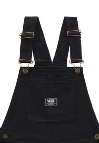 Salopette in denim nero con bretelle regolabili in metallo dorato, una tasca frontale e un'etichetta Vans sulla tasca del petto.