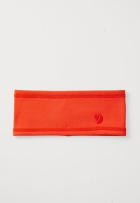 Bright orange fabric headband with stitched edges and a small fox logo embroidered on one side, laid flat on a white surface.