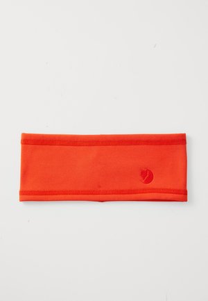 Bright orange fabric headband with stitched edges and a small fox logo embroidered on one side, laid flat on a white surface.