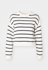 Maglione corto color crema con strisce blu navy, caratterizzato da un colletto e maniche a costine. Realizzato in materiale lavorato a maglia, ha una vestibilità comoda.
