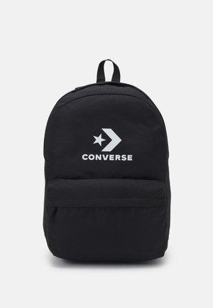 Zaino in canvas nero con spallacci regolabili, una tasca frontale con zip e il logo "CONVERSE" bianco insieme a una grafica di stella.