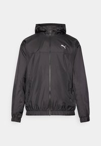 Svart vindjacka i lätt material. Har dragkedja fram, huva, elastiska ärmmuddar och sidofickor. Puma-logotyp på bröstet.