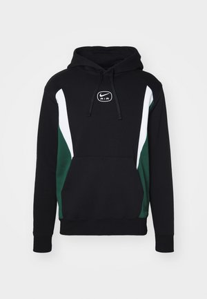 Sweat à capuche en tissu noir, avec des panneaux latéraux blancs et verts, et un logo Nike Air en central. Comprend une poche frontale.