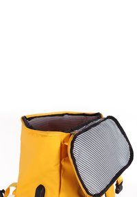 Yellow backpack with a zippered top and a striped black and white flap. Made of durable material, featuring an exterior pocket and black accents.