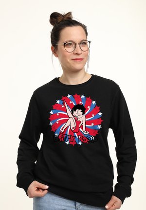 Czarny sweatshirt z kolorową grafiką Betty Boop, z czerwonym, białym i niebieskim spiralnym wzorem oraz akcentami w kształcie gwiazdek.