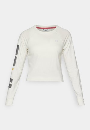 Light cream long-sleeve crop top with raglan sleeves, featuring a small logo on the chest and graphic accents on the left sleeve.